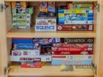 A cabinet full of games and puzzles for great family fun.